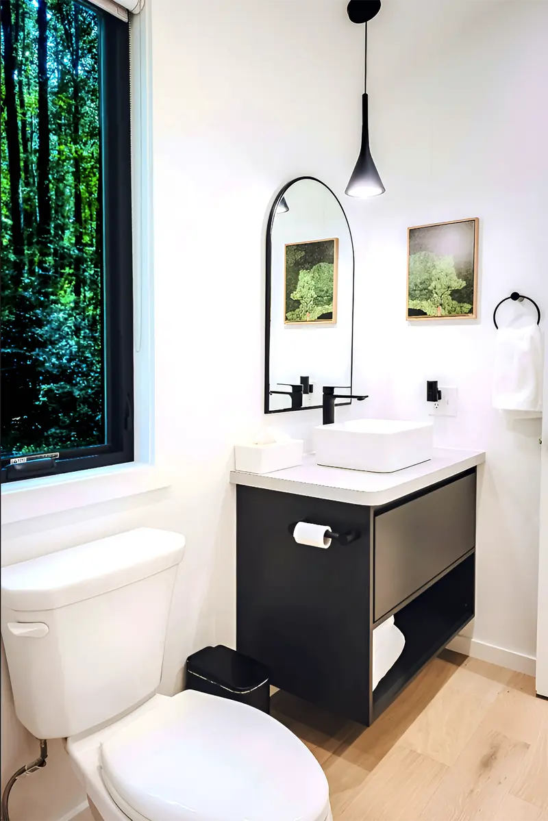 Modern bathroom with black floating vanity and arched mirror